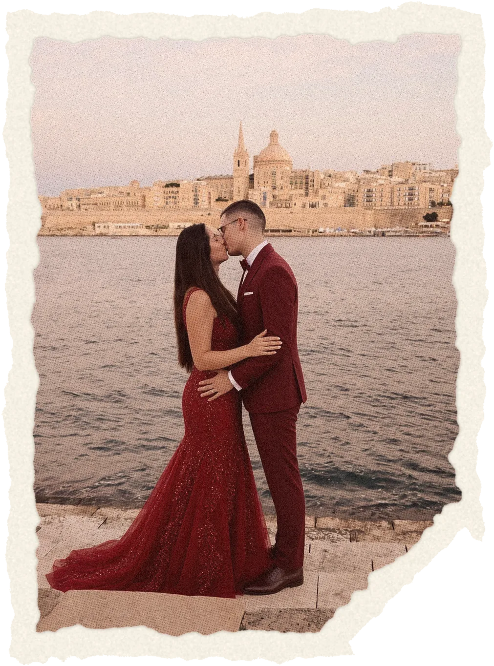 Jen and Axel kissing with Valletta behind them